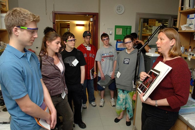 A woman speaks to a group of students in the lab.